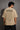 Model wearing a beige POPCASE 5 Pandav oversized t-shirt featuring a large graphic of 'Pandav' in Hindi, '05', and warrior icons. Premium streetwear. - beige
