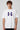 Model wearing white POPCASE Fernando Alonso oversized t shirt with navy blue crackled Have To Win 14 design and Alonso signature