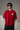 CHAL brand red oversized t-shirt with white graphic print of dice and text. Model wearing the t-shirt to showcase the relaxed, oversized fit. - red