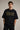 Man wearing a black AC/DC t-shirt against a plain background