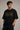 Man wearing a black AC/DC t-shirt against a neutral background