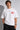 Man wearing a white t-shirt with 'BRAND STATE' in red text on a plain background