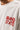 White oversized streetwear t-shirt for men with minimalist red typography chest print and relaxed premium cotton fit