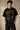 Beige oversized t-shirt with 'HORCRUXES' graphic and iconic Harry Potter items, showcasing premium cotton fabric and relaxed fit. - black