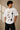 Beige oversized t-shirt with 'HORCRUXES' graphic and iconic Harry Potter items, showcasing premium cotton fabric and relaxed fit. - white