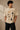 Beige oversized t-shirt with 'HORCRUXES' graphic and iconic Harry Potter items, showcasing premium cotton fabric and relaxed fit. - beige