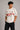 Beige oversized t-shirt with large red and black HOT WHEELS 'Original Since 1968' graphic print on the front, showcasing premium fabric texture.