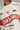 Beige oversized t-shirt with large red and black HOT WHEELS 'Original Since 1968' graphic print on the front, showcasing premium fabric texture.
