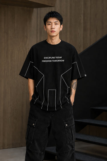 BLESS black oversized t-shirt with white graphic text 'DISCIPLINE TODAY FREEDOM TOMORROW' and abstract geometric lines. - black