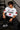 Back view of a man wearing a white LA 32 Drive oversized t-shirt with black text graphic. Model wears black cargo pants.