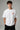 Model wearing white POPCASE Max Verstappen Red Bull oversized t shirt with Red Bull chest logo and large REDBULL race car back graphic
