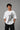 POP-MOUNTAIN-CLIMBER oversized t-shirt in white, featuring a striking black and white graphic of a mountain climber. Designed for ultimate comfort and streetwear style.