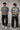 Model wearing an anthracite black Mbappe oversized t-shirt with gold "MBAPPE" graphic and signature, Real Madrid and number 7 logos on sleeves. - stone grey