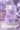 Purple phone case with butterfly designs on a marble stand with a soft purple background