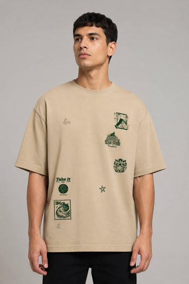 Back view of a man wearing a beige RARE INSIGHT oversized t-shirt with a green "Sorry But I Don't Care" graphic and star accents. - beige