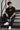 Man wearing FROM THE NORTH oversized t-shirt in beige with black cargo pants and white sneakers. Features The North Face logo and graphic on front and back.