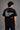 Black QUICKE oversized t-shirt featuring bold white graphic print on the chest and back. Showcasing premium fabric details and relaxed fit. - black