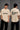 Black QUICKE oversized t-shirt featuring bold white graphic print on the chest and back. Showcasing premium fabric details and relaxed fit. - beige