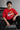 Model wearing a black oversized t-shirt with a vintage Hot Wheels graphic and flames. The tee has a relaxed fit and is paired with black pants.