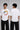 Model wearing a black oversized t-shirt with a vintage Hot Wheels graphic and flames. The tee has a relaxed fit and is paired with black pants. - white