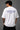 White POPCASE oversized tshirt with i'm not cristiano ronaldo but i also hate losing quote in navy on back, POPCASE Since 2022 tagline