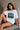 Woman wearing a white t-shirt with Van Gogh artwork sitting on stairs.