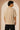 Unbroken Design oversized t-shirt in a beige hue featuring a detailed, stylized brown and green bull graphic print and "UNBROKEN" text across the chest. Showcases ribbed neckline.