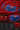 Red oversized t-shirt featuring a bold, blue and orange graphic of Ashwathama's eyes with "The Cursed Warrior" text. Model wearing the t-shirt.