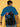 Person wearing a blue t-shirt with a superhero character on a motorcycle and shield.