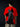 Person wearing a red t-shirt with a Batman graphic on the back against a black background