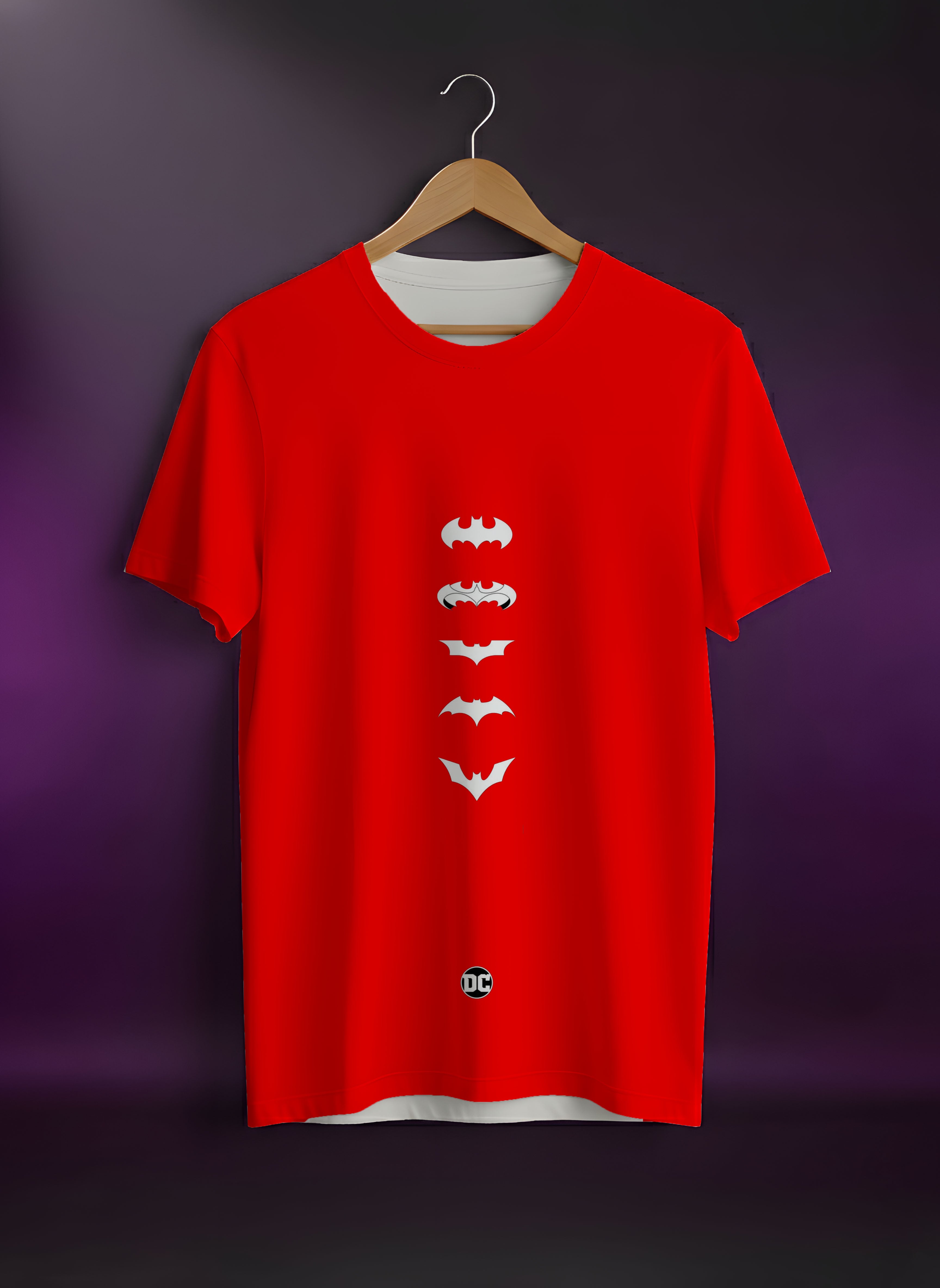 Red t-shirt with white batman logo on a wooden hanger against a dark background