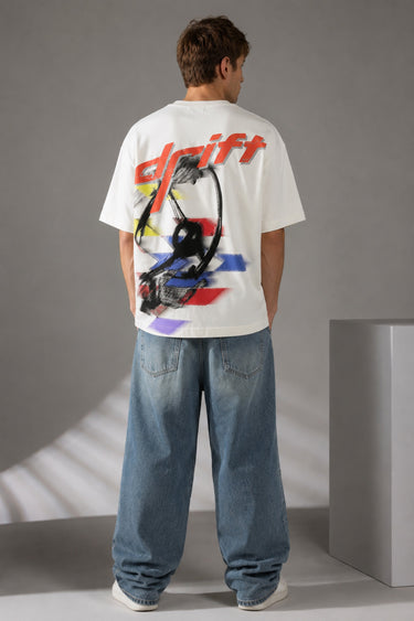 Red oversized t-shirt with 'Drift' graphic print in white and abstract black and yellow brush strokes. Focus on fabric texture and crew neckline. - white