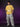 Person wearing a yellow t-shirt with a graphic design on a purple background