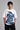 Man wearing a black kuwansugg DESIGN oversized t-shirt with a white graphic print of a knight on a horse. The t-shirt is made of premium cotton.