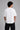 Man wearing a black kuwansugg DESIGN oversized t-shirt with a white graphic print of a knight on a horse. The t-shirt is made of premium cotton.