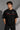 Black Mercedes-Benz and AMG oversized t-shirt with red stripe detail. Features the iconic Mercedes-Benz star logo and AMG lettering. Styled for a premium streetwear look. - black
