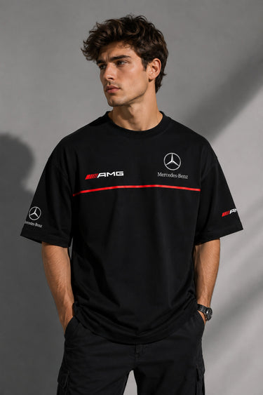 Black Mercedes-Benz and AMG oversized t-shirt with red stripe detail. Features the iconic Mercedes-Benz star logo and AMG lettering. Styled for a premium streetwear look. - black