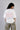 White oversized t-shirt from The Six Design featuring a bold red and blue graphic print of the numbers 3, 6, and 9. The t-shirt has a relaxed fit and is made of premium cotton.