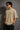 Model wearing a beige POPCASE 5 Pandav oversized t-shirt featuring a large graphic of 'Pandav' in Hindi, '05', and warrior icons. Premium streetwear.