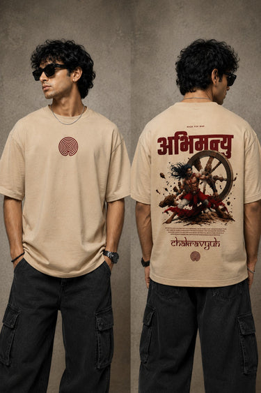White oversized t-shirt with a bold graphic of the warrior Abhimanyu in front of a chariot wheel. Text includes "Made For War" and "Abhimanyuh" in Hindi. Detailed fabric information and care instructions are shown. - beige