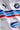 Man wearing a white BMW oversized t-shirt with blue, light blue, and red stripes across the chest and a black Puma logo and BMW M Motorsport emblem.