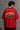Red BIG BOY TOYZ x Hot Wheels oversized t-shirt featuring a vintage red Hot Wheels car graphic, checkered flag pattern, and brand logos. Showcase print quality and fabric.