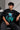 Man wearing a black BROKEN CODE oversized t-shirt with a glitch art graphic of eyes and text. Features a chain necklace and dark wash jeans. Model is posed against a studio backdrop.