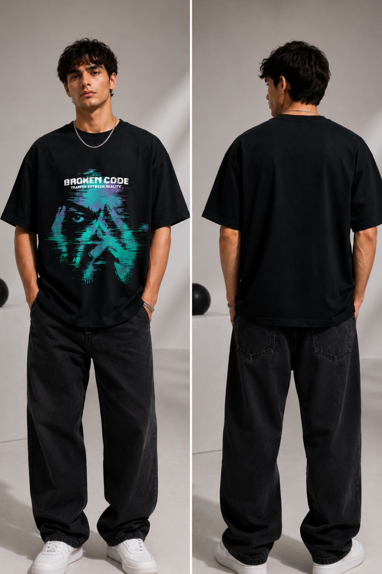 Man wearing a black BROKEN CODE oversized t-shirt with a glitch art graphic of eyes and text. Features a chain necklace and dark wash jeans. Model is posed against a studio backdrop.