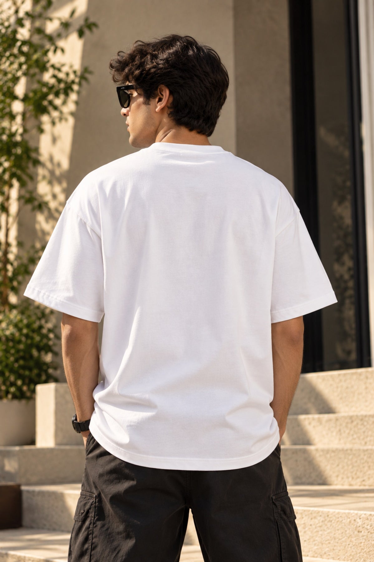 White oversized tshirt with vibrant pop art dual panel cartoon and fashion figures illustration on chest, drop shoulder boxy fit, men India