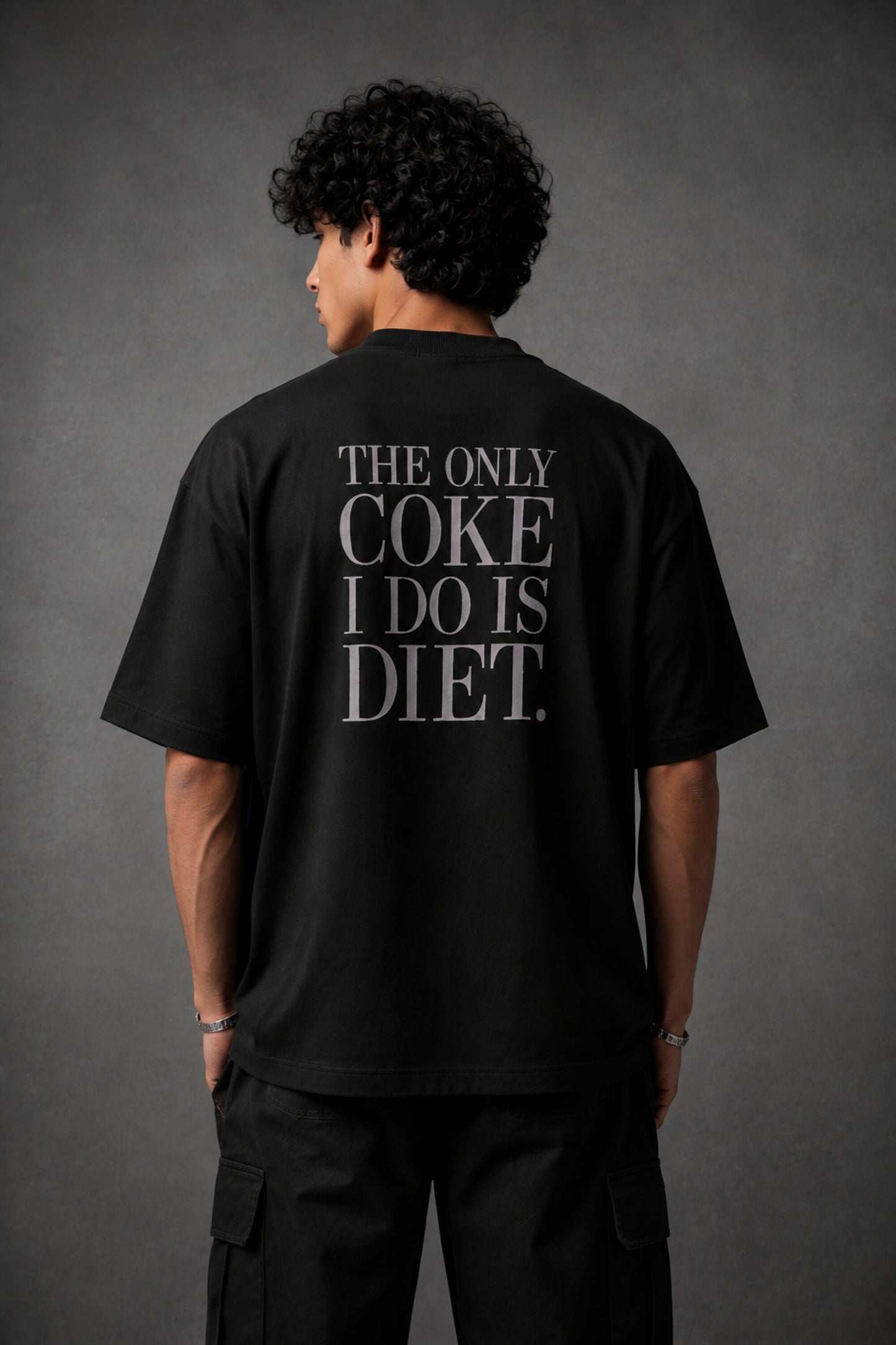 Black oversized t-shirt with hyper-realistic crushed Diet Coke can chest graphic