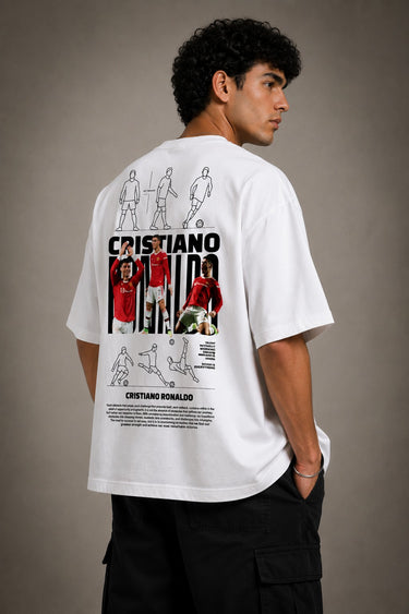 Man wearing a white CR7 oversized t-shirt with black CR7 logo. Studio shot with grey background.
