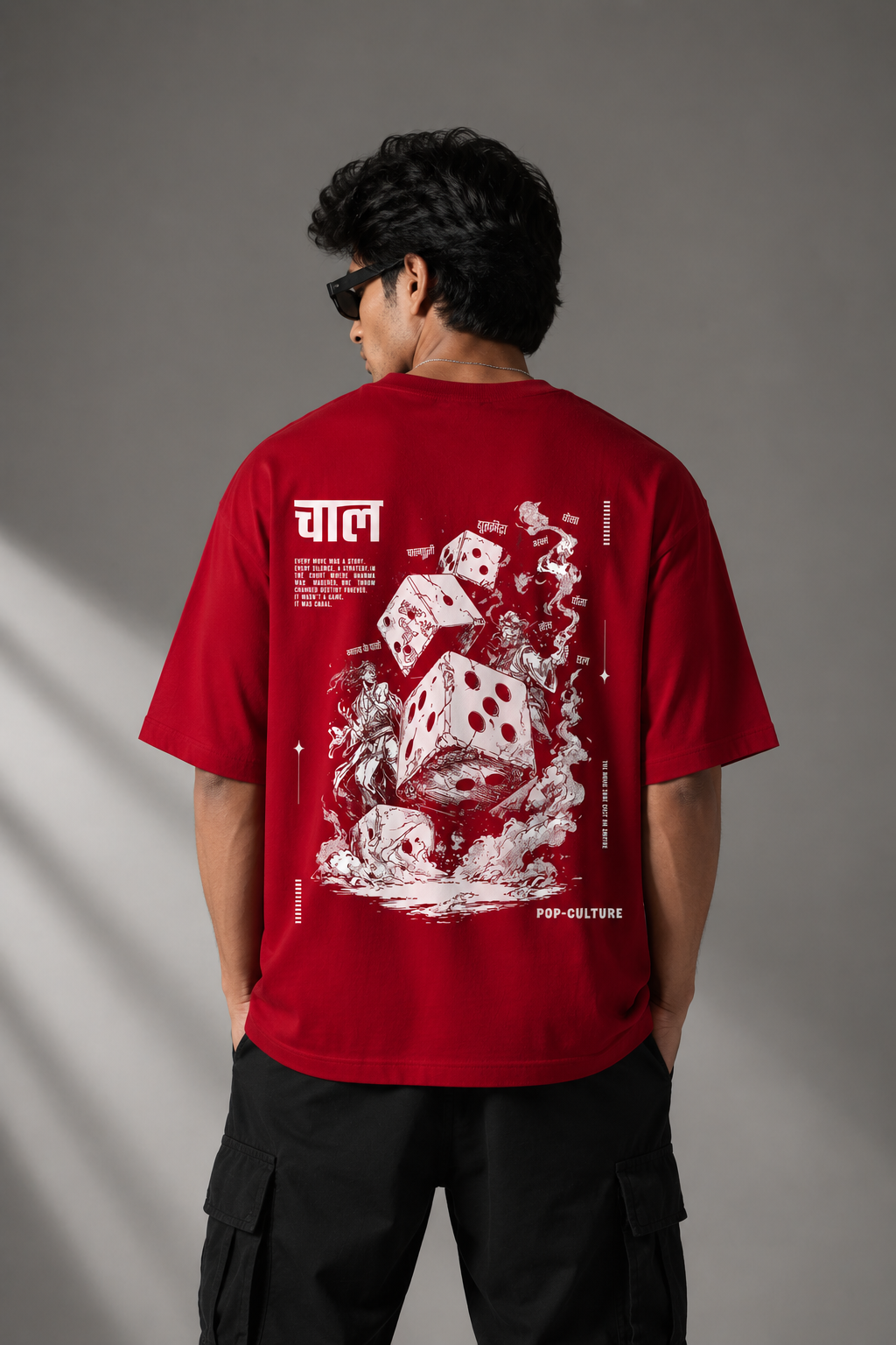CHAL brand red oversized t-shirt with white graphic print of dice and text. Model wearing the t-shirt to showcase the relaxed, oversized fit.
