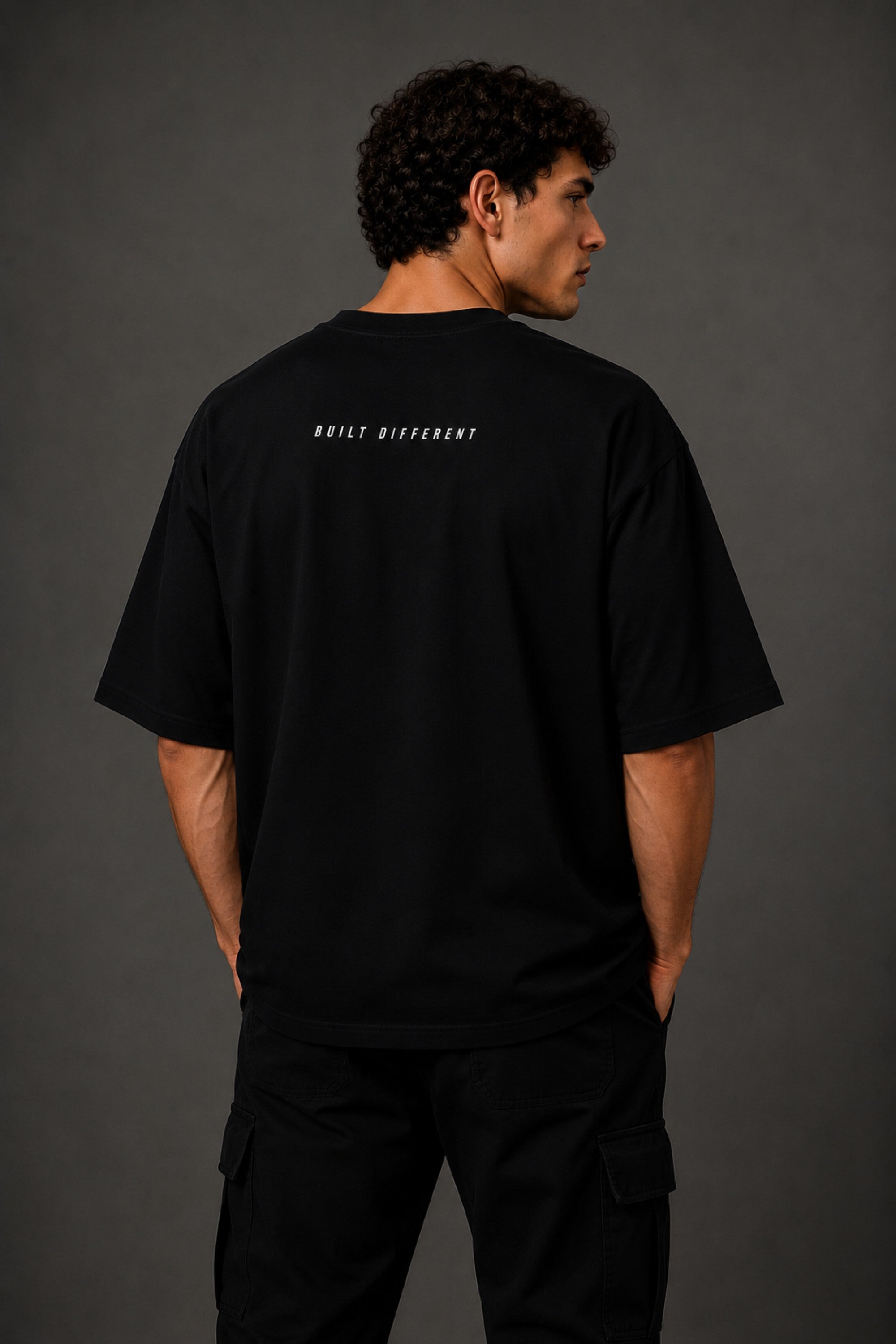 Black oversized t-shirt with 'Chicago' graphic print and racing-inspired logos. Offers premium streetwear style.