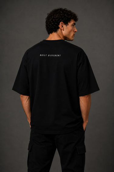 Black oversized t-shirt with 'Chicago' graphic print and racing-inspired logos. Offers premium streetwear style.